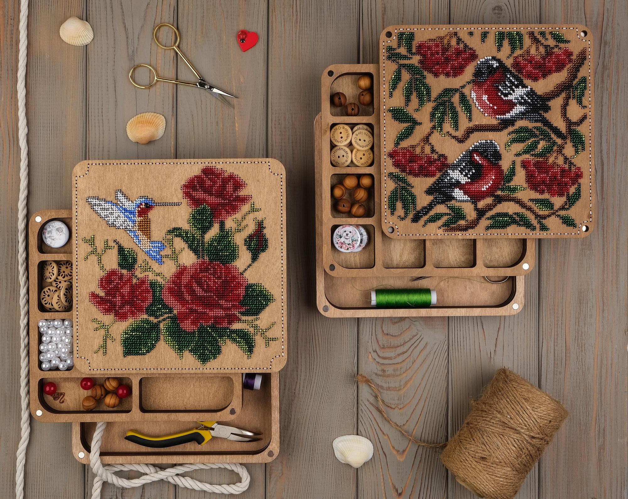 Series of embroidered motifs laid out on table